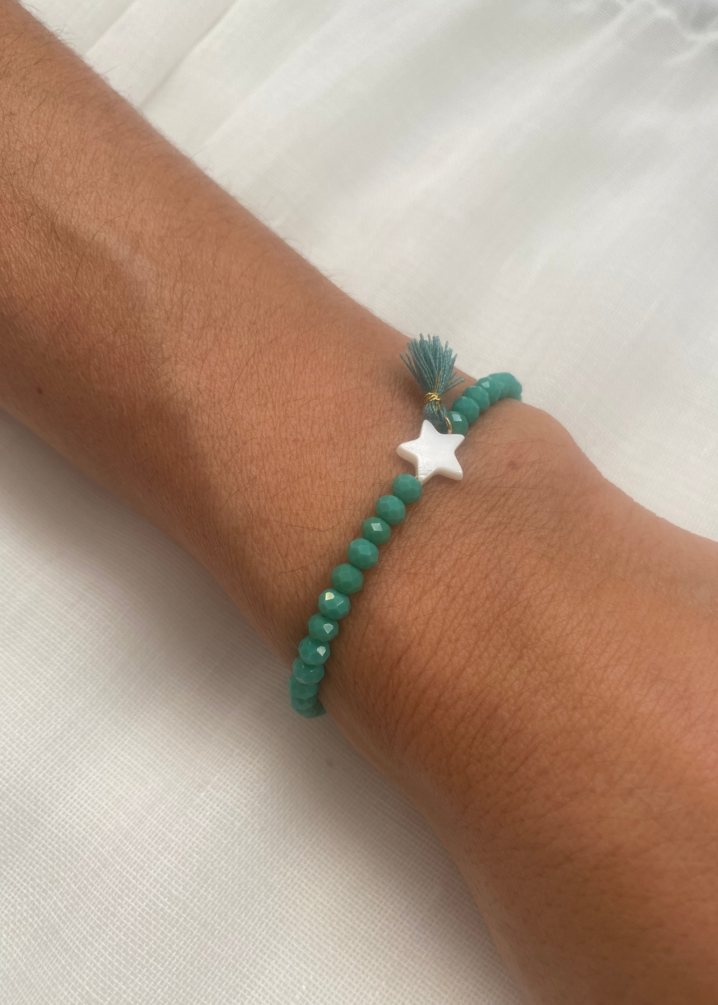 Pulsera estrella pompón