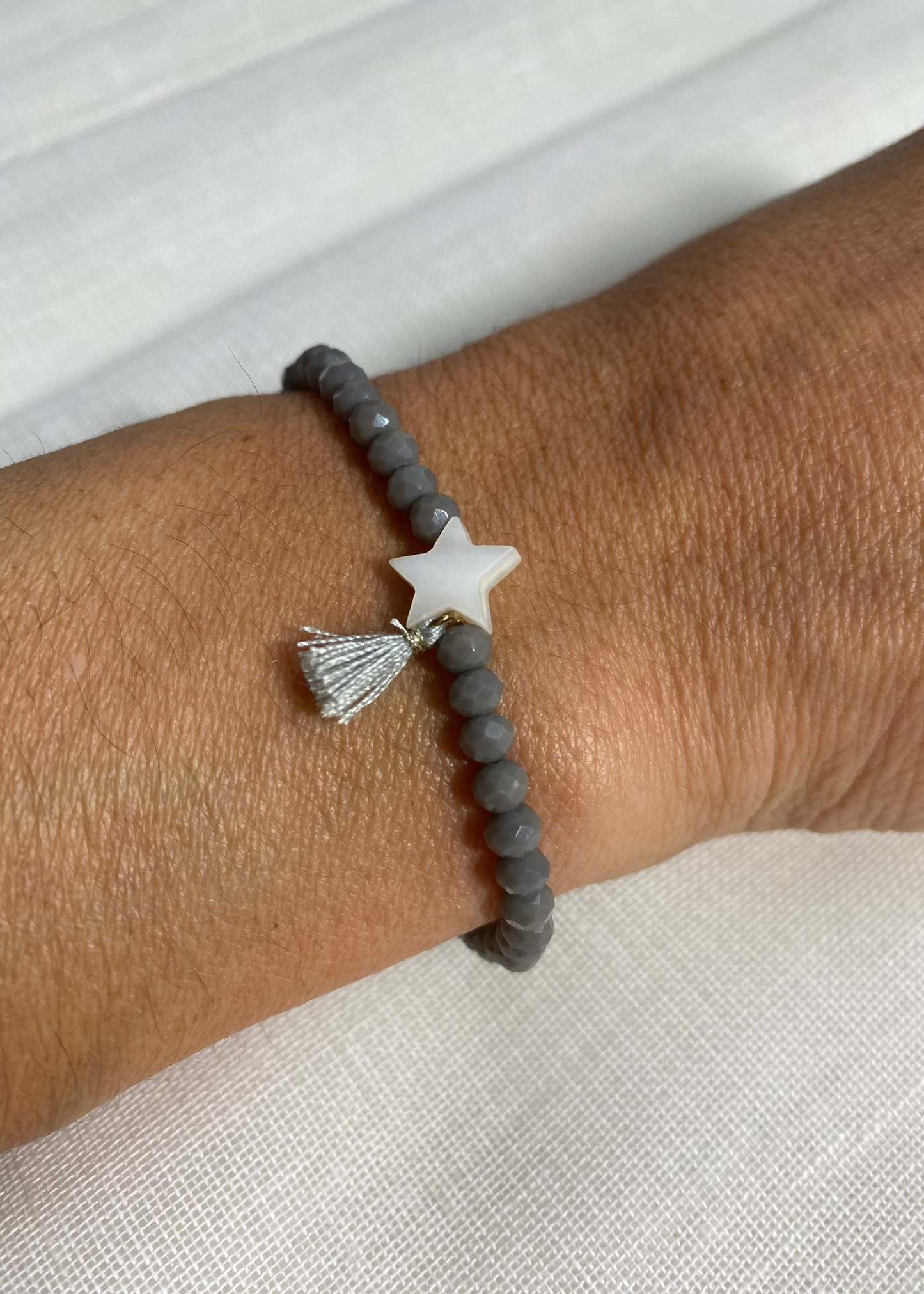 Pulsera estrella pompón