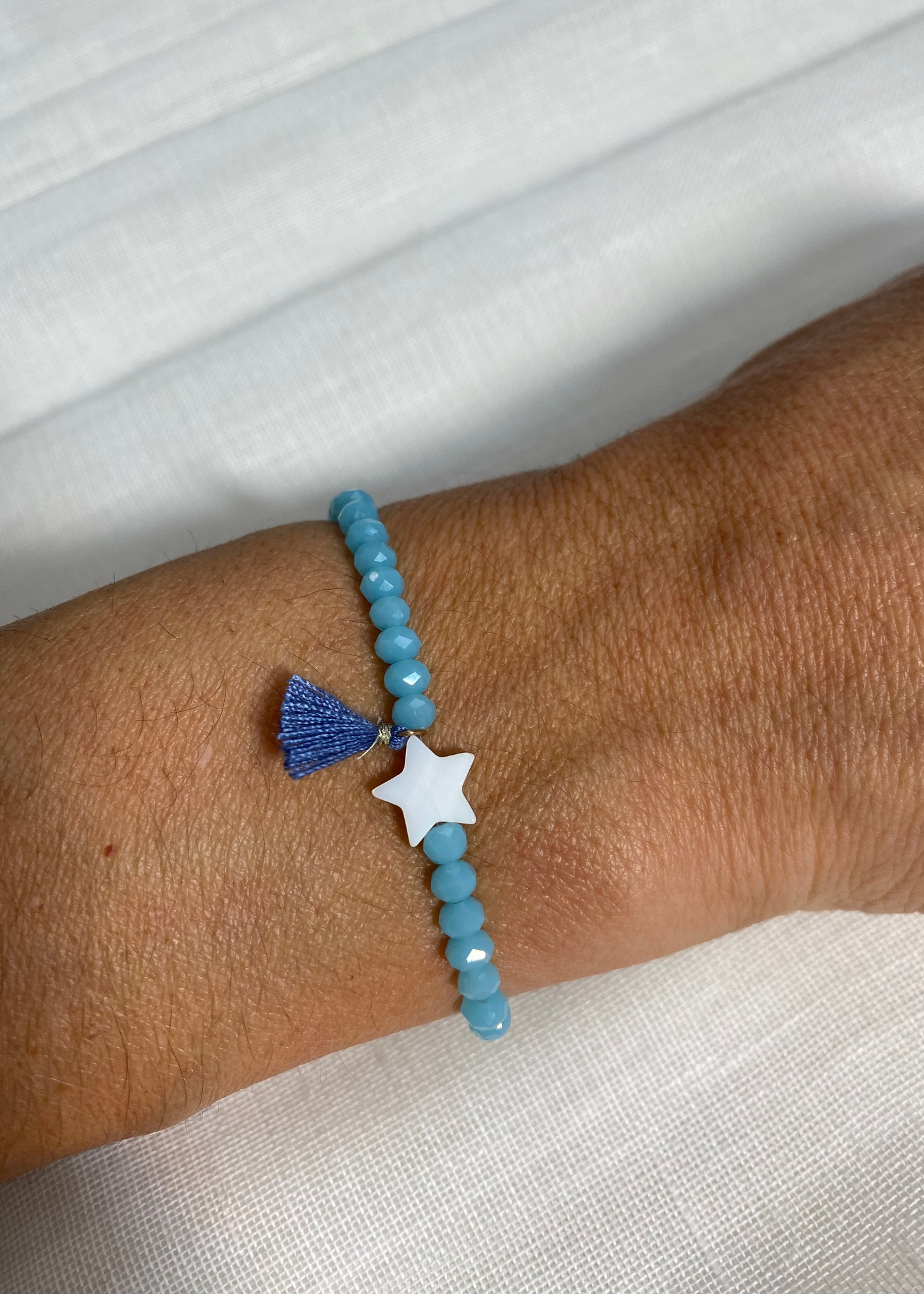 Pulsera estrella pompón